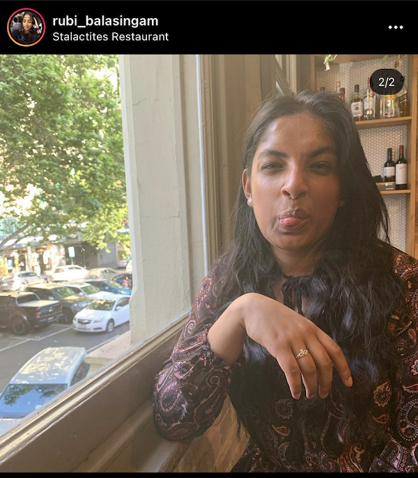 Young South Asian woman being goofy and pulling faces in a restaurant